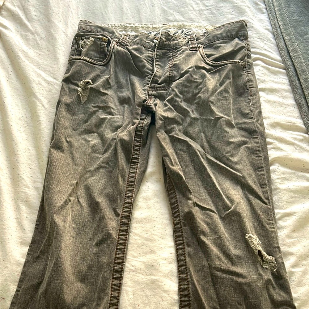Stitch jeans, faded gray with designer ripping and distress in the hip & thigh